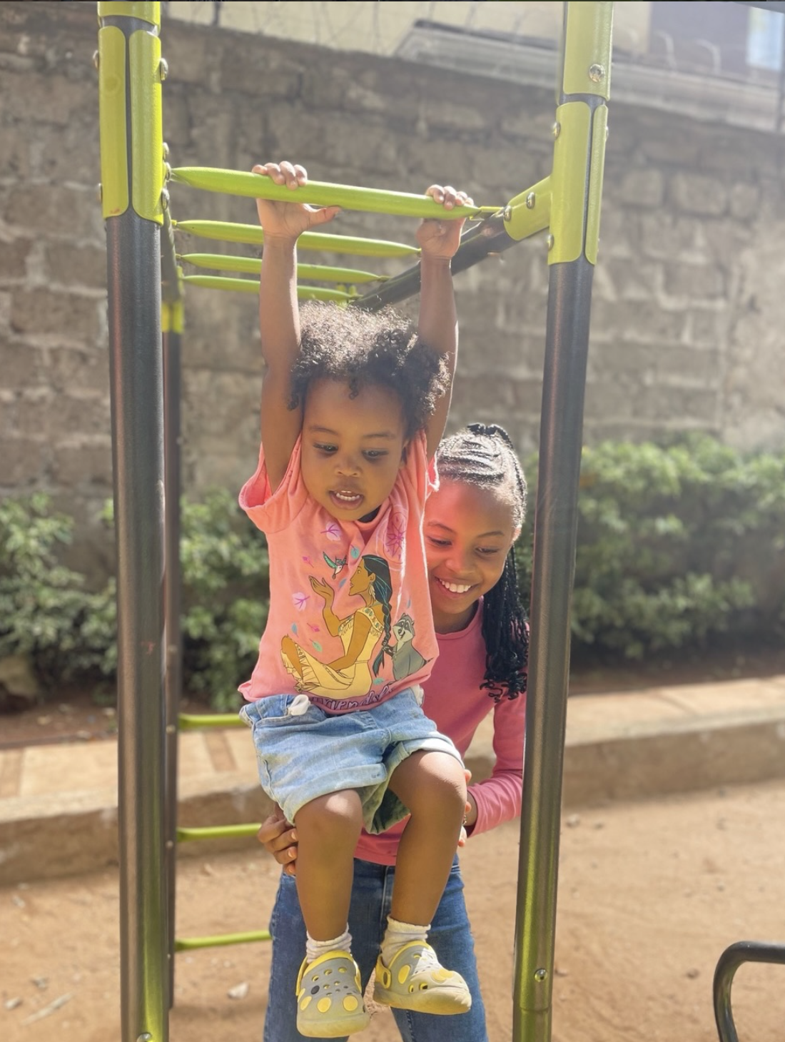 Children playing on outdoor equipment at Kids Nook